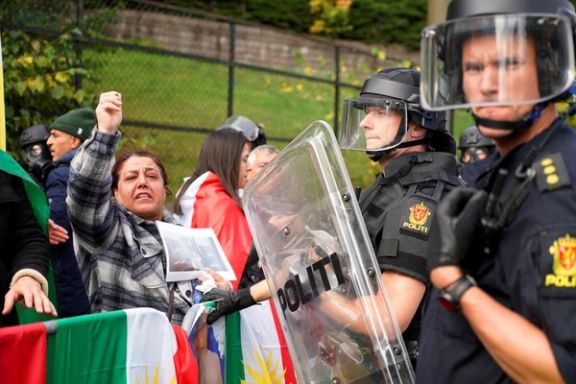 Police officers stand guard as people attend a demonstration at Iran's embassy in Oslo, Norway, September 29, 2022.