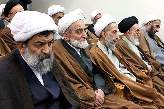 A group of older clerics bored during an official ceremony.