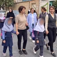 Bareheaded mother, veiled daughter: Iran's schools keep a rule its streets have dropped