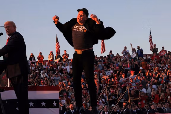 Tesla CEO and X owner Elon Musk reacts next to Republican presidential nominee and former US president Donald Trump during a campaign rally, at the site of the July assassination attempt against Trump, in Butler, Pennsylvania, U.S., October 5, 2024.
