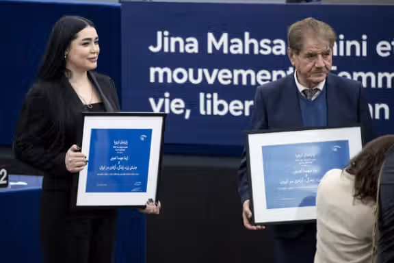 Afsoon Najafi (left), the sister of slain protester Hadis Najafi, and Saleh Nikbakht, the lawyer of Mahsa Amini's family during the European Parliament Sakharov Prize ceremony in Strasbourg, eastern France, December 12, 2023