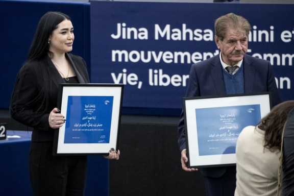 Afsoon Najafi (left), the sister of slain protester Hadis Najafi, and Saleh Nikbakht, the lawyer of Mahsa Amini's family during the European Parliament Sakharov Prize ceremony in Strasbourg, eastern France, December 12, 2023