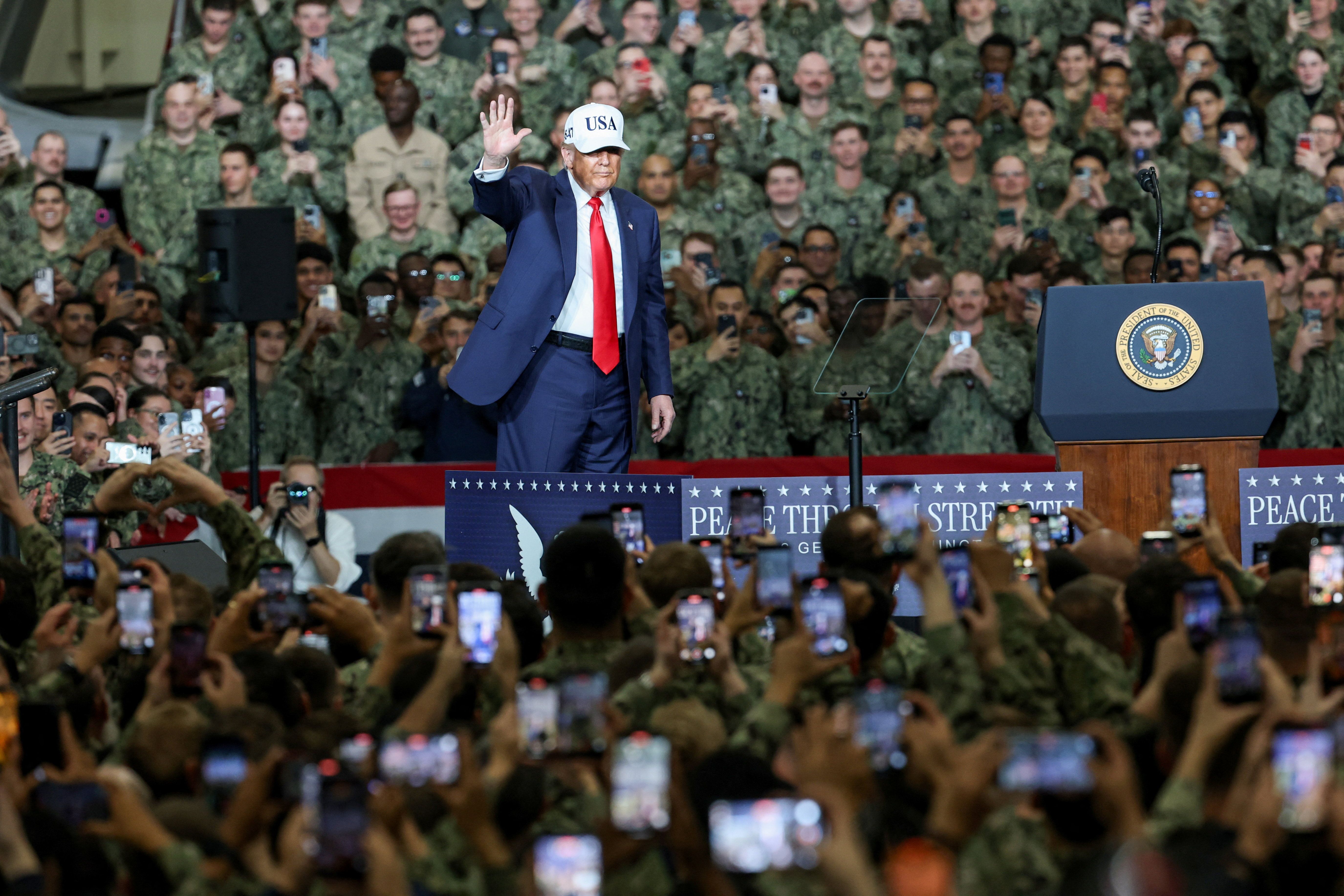 US President Donald Trump gestures on the aircraft carrier USS George Washington during his visit to the US Navy's Yokosuka base in Yokosuka, Japan, October 28, 2025.
