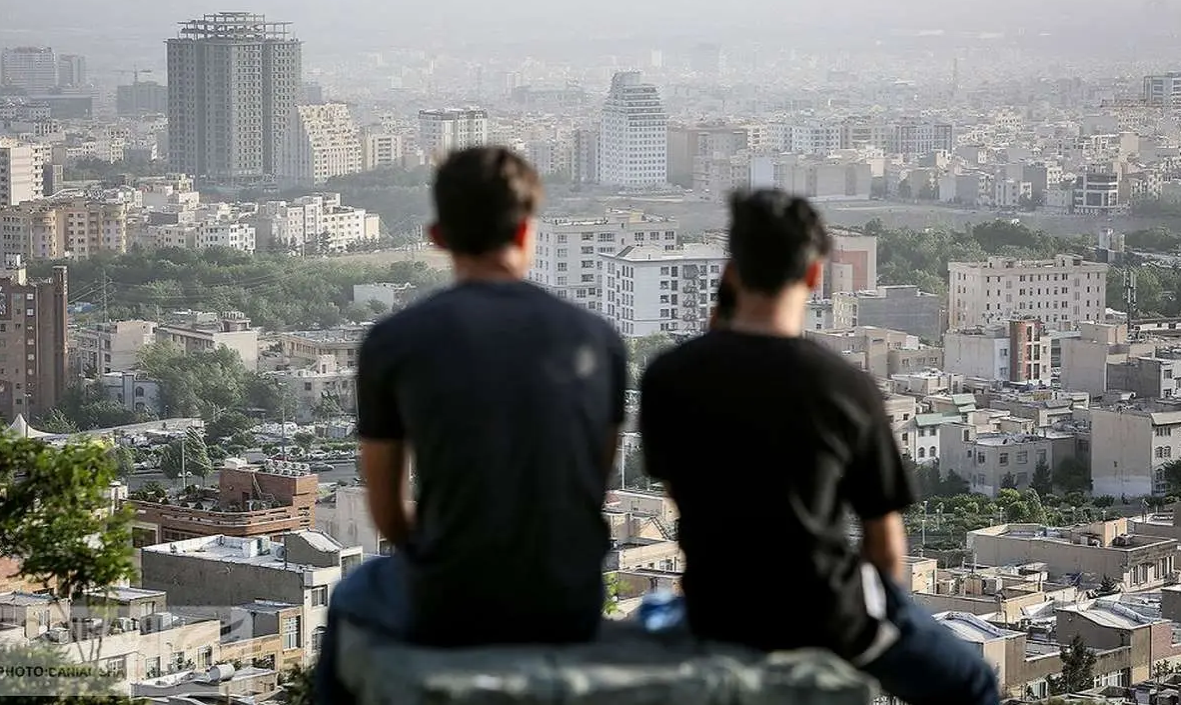 Two men overlook Tehran in this undated file photo illustrating Iran’s housing and rent crisis.