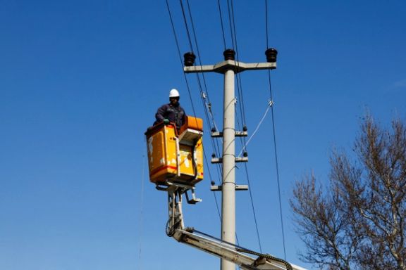 A technician works on an electrical line in the aftermath of a deadly earthquake in Kahramanmaras, Turkey, February 8, 2023.