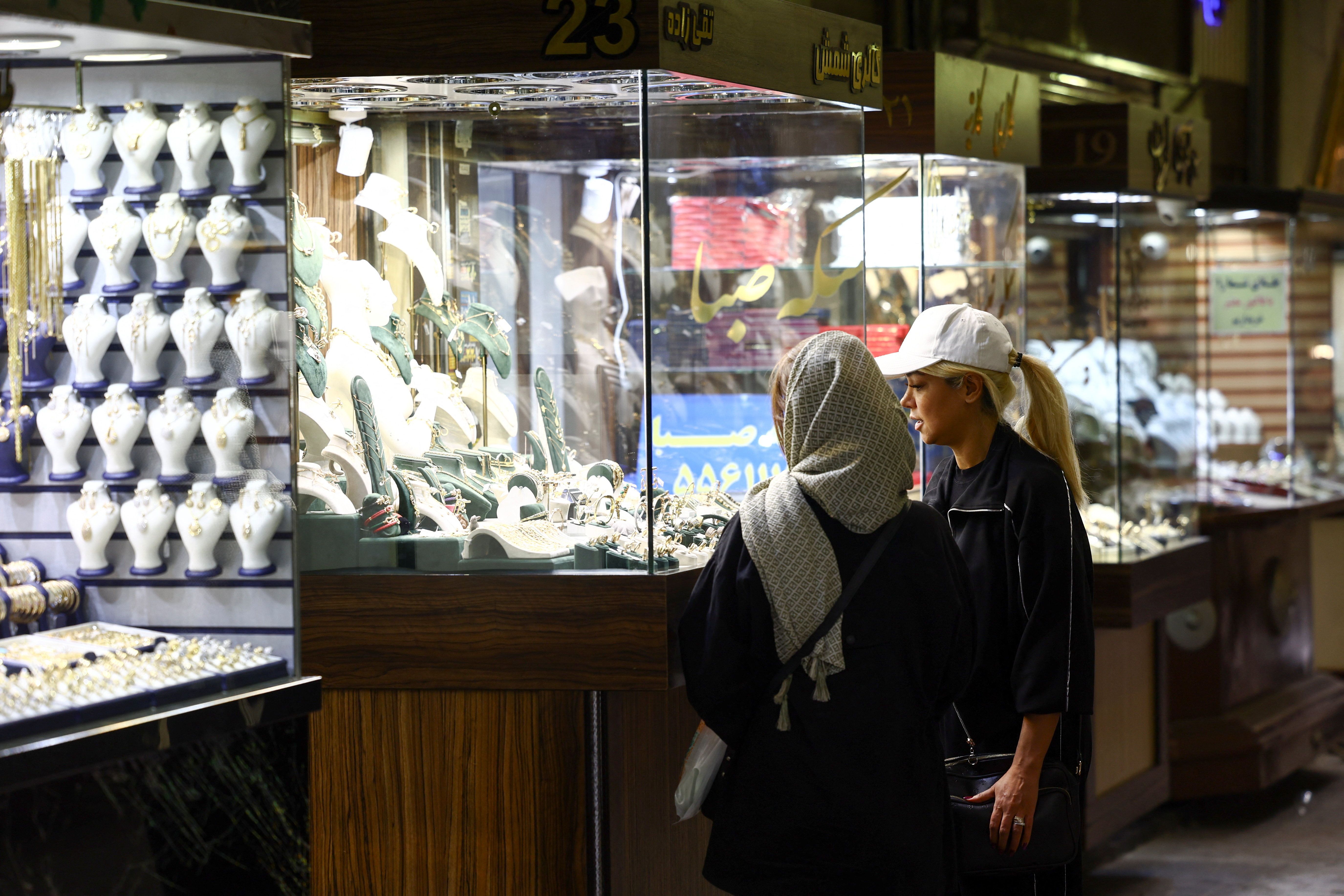 Women look at the gold shop display in Tehran Bazaar, amid a ceasefire between US and Iran, in Tehran, Iran, April 21, 2026. 
