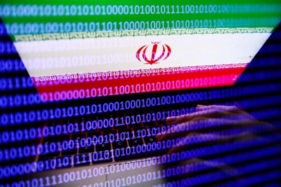 Flag of Iran displayed on a laptop screen and binary code displayed on a screen