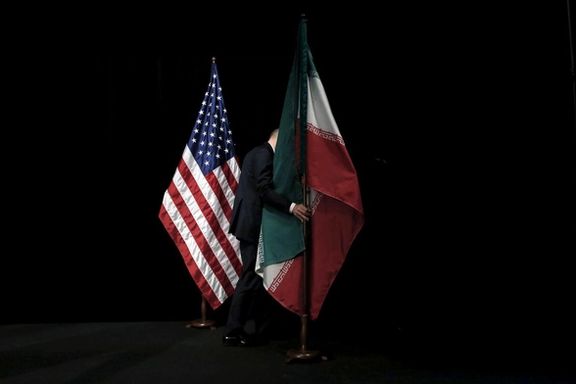 A staff member removes the Iranian flag from the stage after a group picture with foreign ministers and representatives of the U.S., Iran, China, Russia, Britain, Germany, France and the European Union during the Iran nuclear talks at the Vienna International Center in Vienna, Austria July 14, 2015.