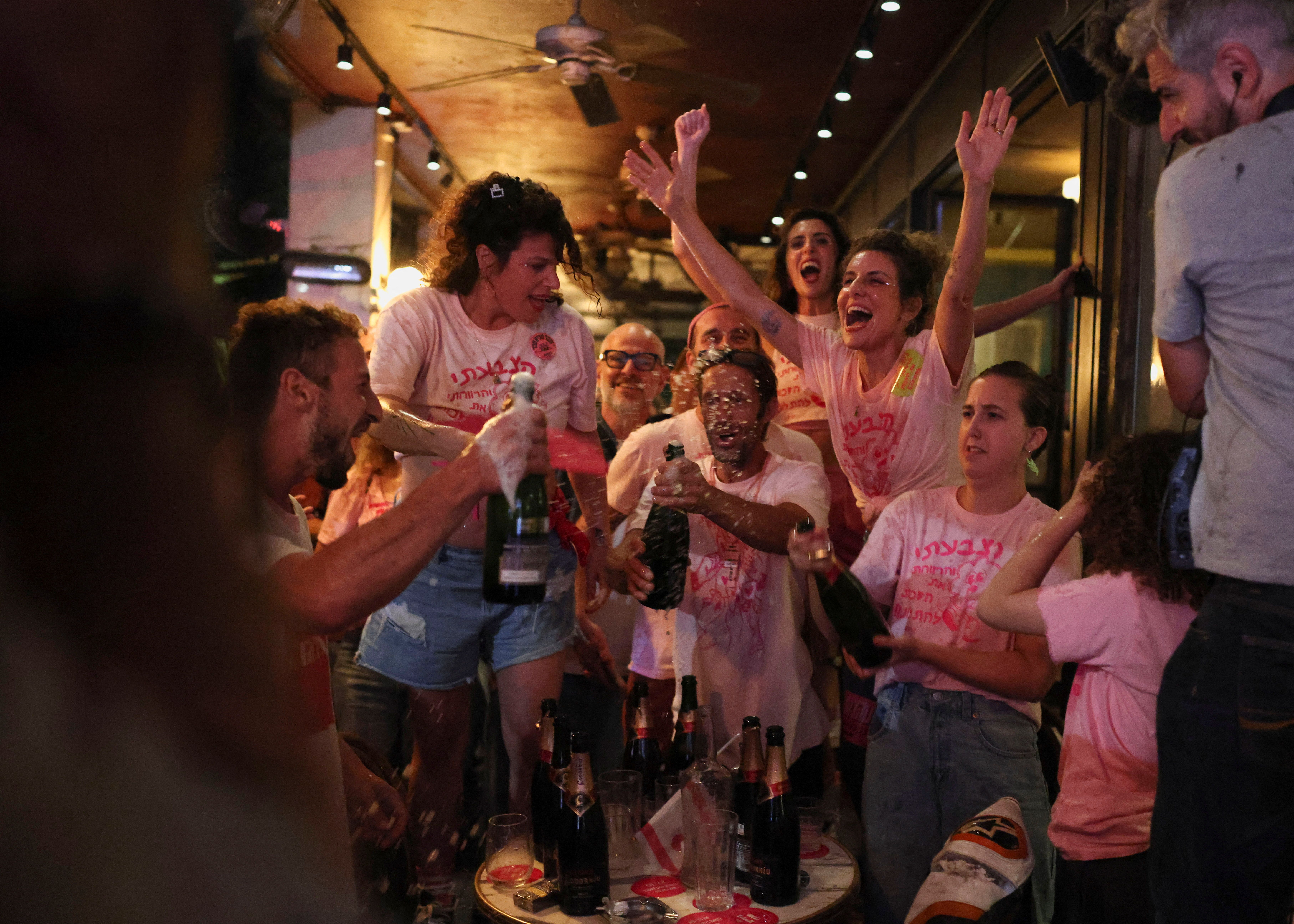 Israelis react to exit polls during the national election, in Tel Aviv, Israel, October 27, 2026. 
