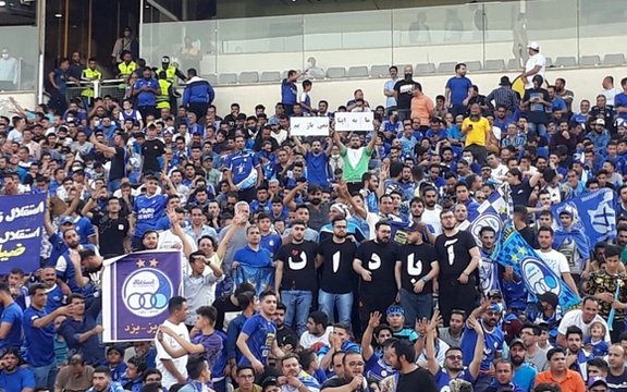 People in Tehran's main soccer stadium unfurl a banner supporting protesters. May 30, 2022