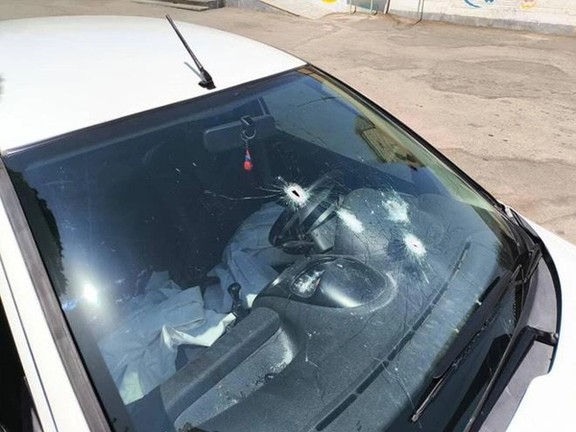 A photo shared by the Amir Kabir Newsletter shows the car that Hooman Kiani was in, with multiple bullet holes in the windshield and shattered glass around the impact points. The white vehicle’s airbags appear deployed inside.