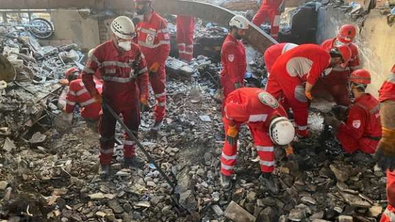 Responders from Iran's Red Crescent attend to the site of an Israeli attack, June 17 2025.