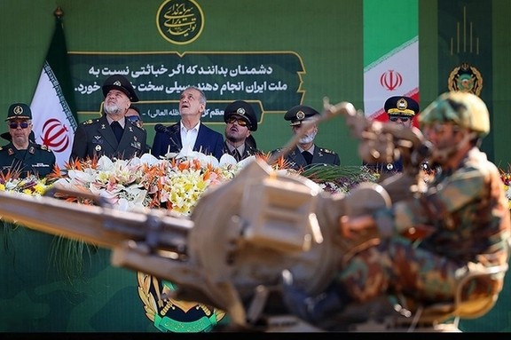 Iranian President Masoud Pezeshkian and the chief of staff of Iran's armed forces Major General Mohammad Bagheri observe the annual Army Day parade in Tehran, April 18 2025.