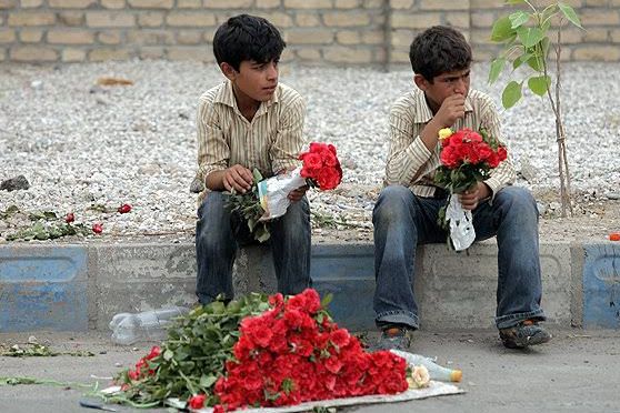 Children selling flowers on a street in Tehran