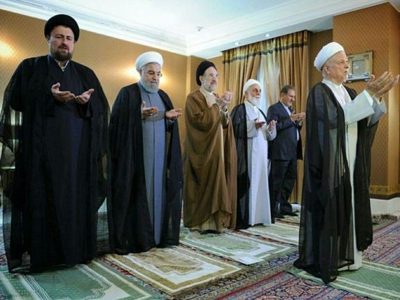 Former president Rafsanjani leading a prayer with Khatami (C) and Khomeini's grandson (L) standing behind him