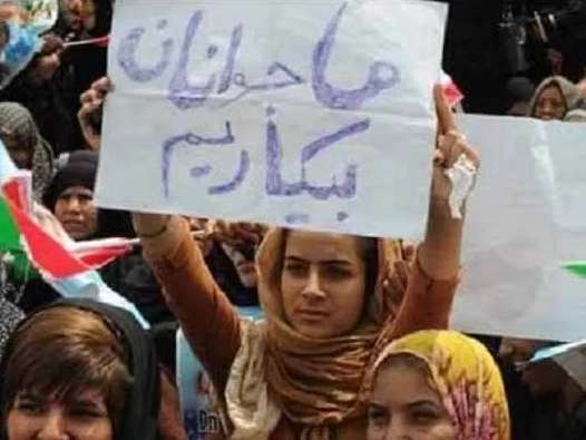 A young woman in Iran holding a sign saying "We the youth are unemployed". Undated