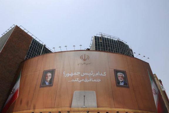 Two portraits of candidates are painted around the presidential chair at a shopping center in Tehran, Iran on July 3, 2024. “Which one is the president? There are differences” is written on the wall.
