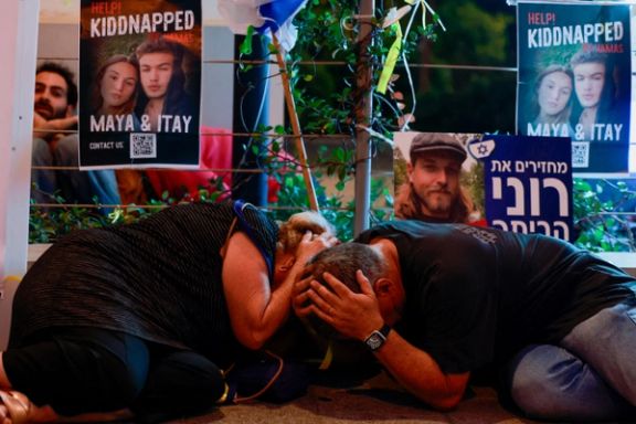 People take cover as sirens of incoming rockets sound, amid the ongoing conflict between Israel and Palestinian Islamist group Hamas, in Tel Aviv, Israel, October 28, 2023.