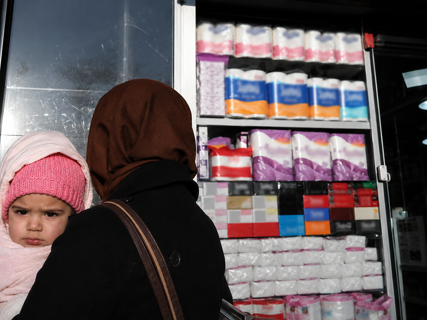 File photo of a woman and child outside a shop in Iran, where soaring inflation and declining purchasing power have deepened concerns over period poverty and access to basic hygiene products for low-income families.