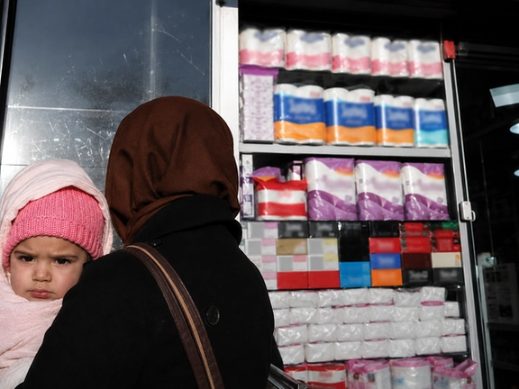 File photo of a woman and child outside a shop in Iran, where soaring inflation and declining purchasing power have deepened concerns over period poverty and access to basic hygiene products for low-income families.