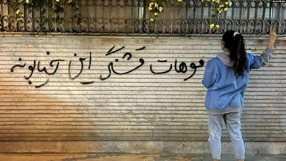  An Iranian woman unveiling in public to protests against the mandatory hijab  