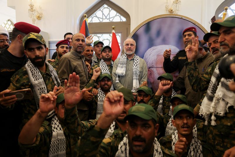Iranian Parliament Speaker Mohammad Bagher Ghalibaf stands with members of Iraq's Popular Mobilization Forces at the grave of Iraqi paramilitary commander Abu Mahdi al-Muhandis, who was killed alongside Iranian military commander Ghassem Soleimani in a US drone strike near Baghdad International Airport in January 2020, in Najaf, Iraq, August 21, 2026.