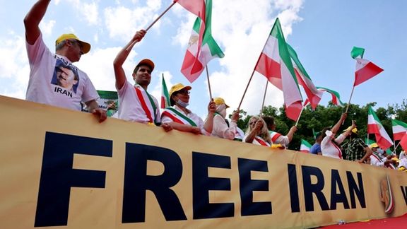 Supporters of the National Council of Resistance of Iran (NCRI) opposition group protest against the Iranian government and use of the death penalty in Iran, at the Brandenburg Gate in Berlin, Germany, July 10, 2021.