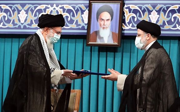 Khamenei handing his decree to President Raisi empowering him to take office. August 3, 2021