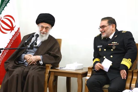 Iran's former national security chief Ali Shamkhani sitting beside Supreme Leader Ali Khamenei