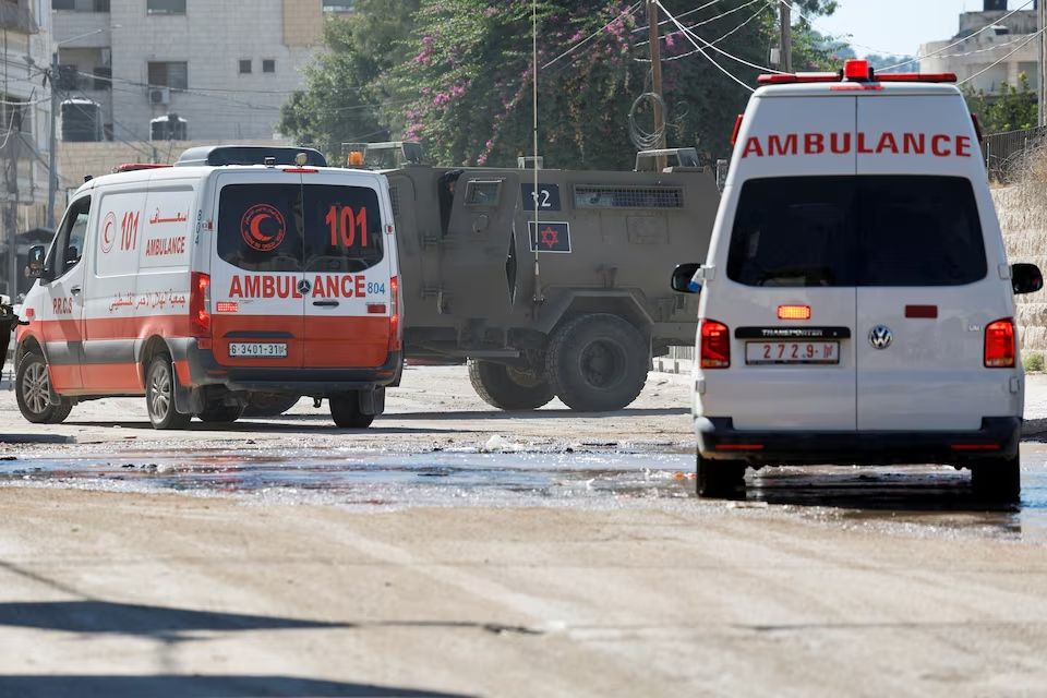 Ambulances respond, as an Israeli military vehicle takes part in a raid, in Jenin, in the West Bank, August 28, 2024.