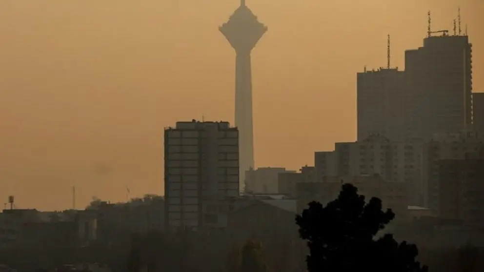 A view of Tehran shrouded in air pollution and experiencing blackouts