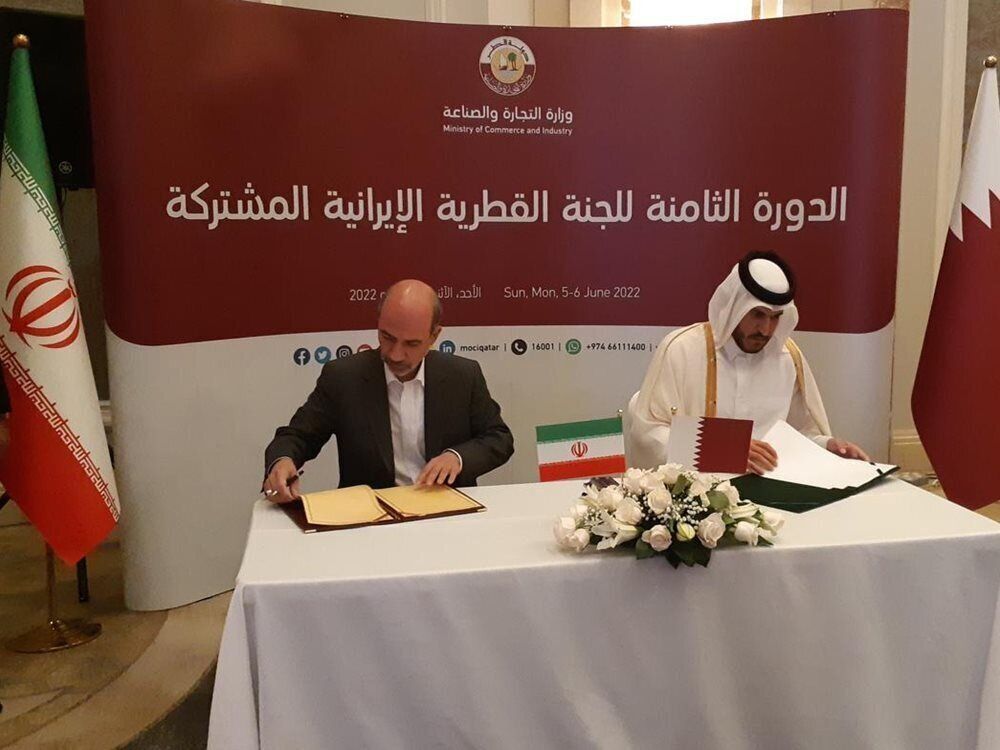 Iran’s Energy Minister Ali-Akbar Mehrabian (L) and Qatar’s Minister of Commerce and Industry Sheikh Mohammed Bin Hamad Bin Qassim Al-Thani sign MOU documents in Doha on June 5, 2022.