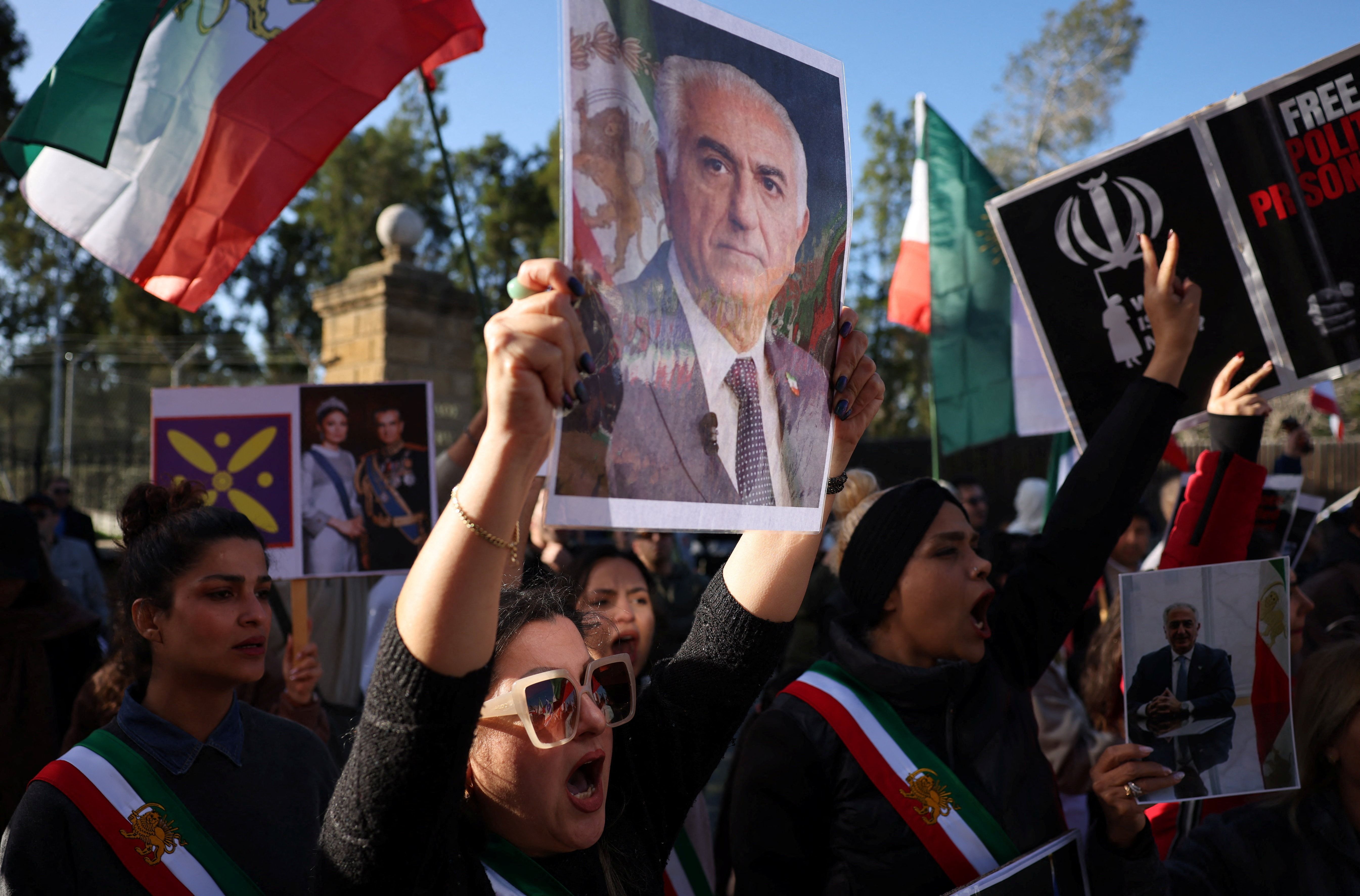 A protester hold Reza Pahlavi's picture during the Munich rally on Feb. 14, 2026