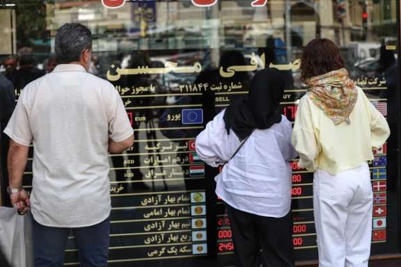 People check the latest rates outside a currency exchange in Tehran, Iran, May 2, 2026