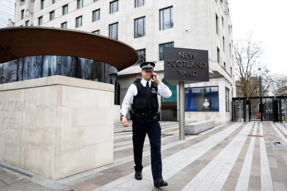 A police officer walks outside New Scotland Yard, the headquarters of the Metropolitan Police, in London, Britain March 21, 2023.