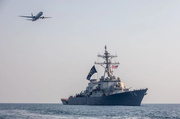 A US Navy P-8A Poseidon maritime patrol aircraft flies above guided-missile destroyer USS McFaul while patrolling the Persian Gulf, Aug. 3, 2023