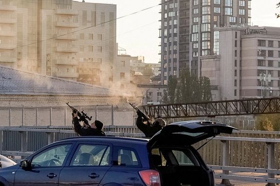 Police officers shoot at a drone during a Russian drone strike, which local authorities consider to be Iranian-made Shahed-136 unmanned aerial vehicles (UAVs), amid Russia's attack on Ukraine, in Kyiv, Ukraine October 17, 2022.