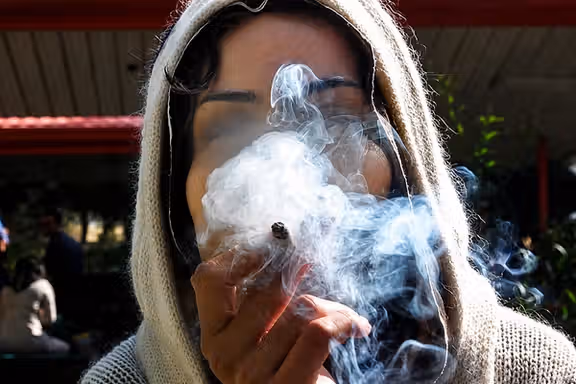 A woman smokes a cannabis cigarette in Iran in this undated file photo.