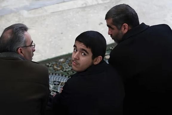 Ali Nikzad and his son at Friday prayers, 2011