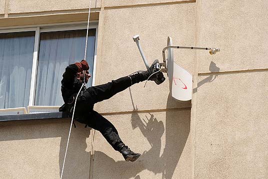 Police destroying a satellite dish in Tehran in 2011