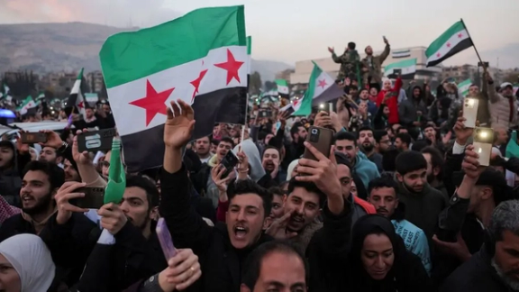 Syrians celebrate the fall of Bashar al-Assad on December 12, 2024.