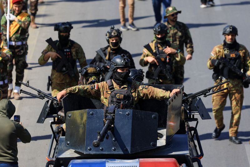 Members of the Iraqi armed group Kataib Hezbollah attend the funeral of their members, who were killed in an airstrike that targeted a Hashd al‑Shaabi headquarters near the western al‑Qaim district on the Syrian border, amid the U.S.-Israel conflict with Iran, in Baghdad, Iraq, March 2, 2026. REUTERS