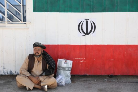 An Afghan man sits at the Dowqarun border crossing between Iran and Afghanistan, Razavi Khorasan Province, Iran August 29, 2021.