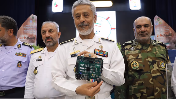 Rear Admiral Habibollah Sayyari, the Coordinating Deputy of the Islamic Republic’s Army, holding a so-called ‘quantum processor’ during a ceremony at the Navy’s Imam Khomeini Maritime University in Noshahr, in the northern province of Mazandaran on June 1, 2023