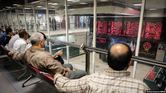 Investors and onlookers watch prices from a gallery in Tehran stock exchange.