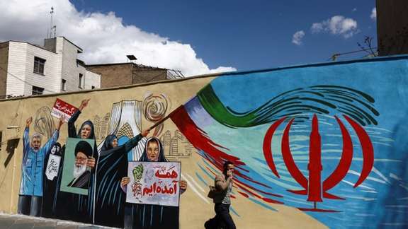 A man walks on a street after US President Donald Trump said that he had agreed to a two-week ceasefire with Iran, in Tehran, Iran, April 8, 2026.