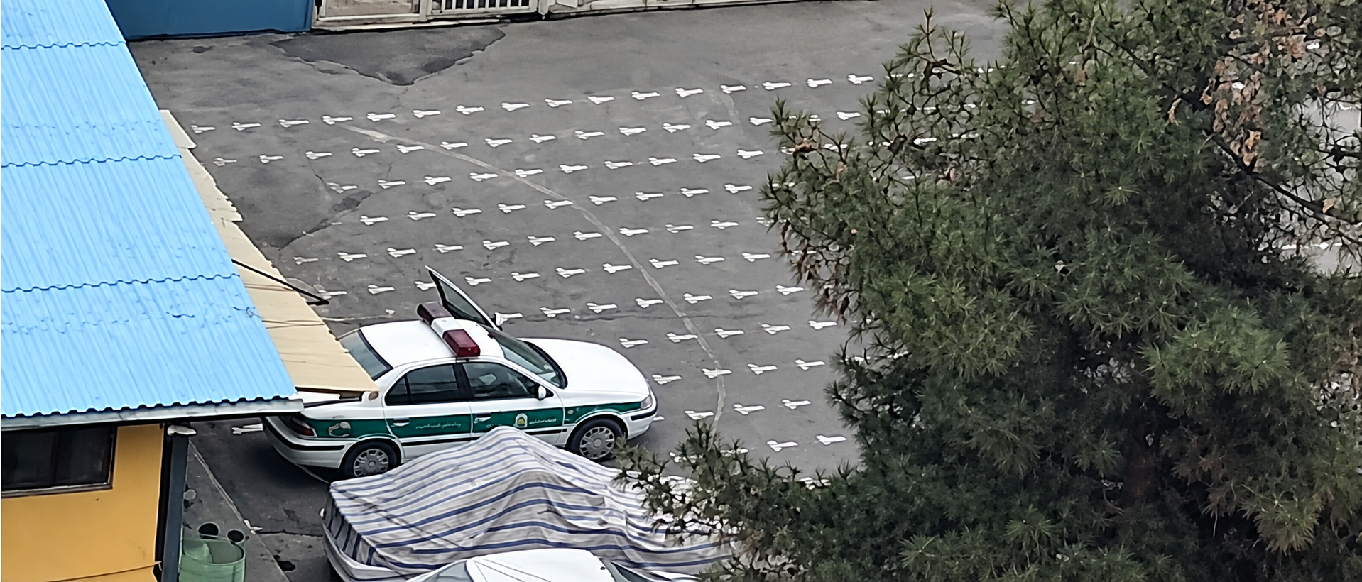 A police vehicle is seen parked in the courtyard of a school in Iran during the US-Israeli war in March 2026.