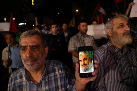 A protester shows a picture of Hezbollah leader Sayyed Hassan Nasrallah on his mobile phone during an anti-Israel protest following an Israeli strike on Lebanon, in Tehran, Iran, September 28, 2024.