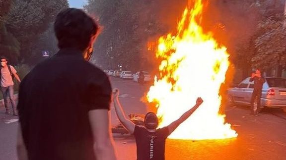 Protesters light a fire in a Tehran street in September 2022