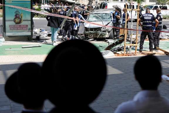 People watch as Israeli police work at the scene of a ramming attack in Tel Aviv, Israel July 4, 2023.